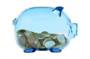 Blue transparent piggy bank with euro coins.
